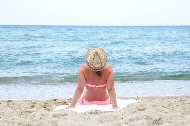 istock Woman Relaxing and Sunbathing  at Beach 1179979771
