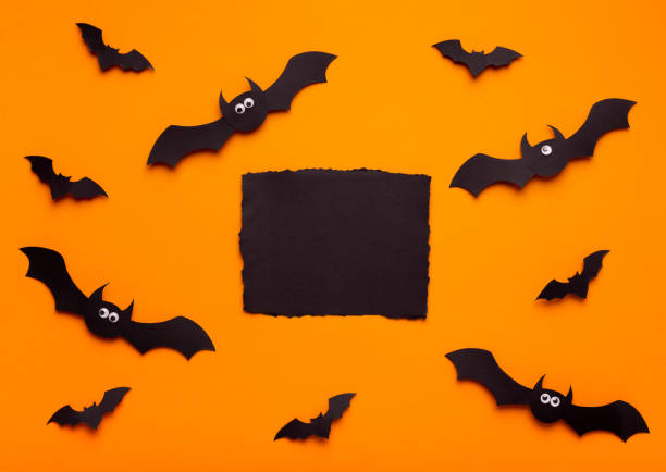 istock Halloween bats surrounding black label for text with empty space 1179980018