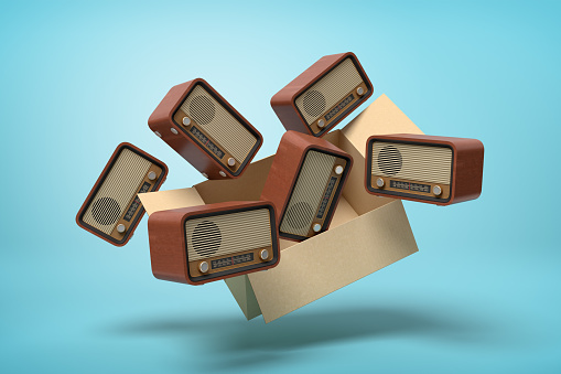 3d rendering of cardboard box full of old-fashioned radios in mid-air on light-blue background. Technology of past. Feeling nostalgic. Garage market.