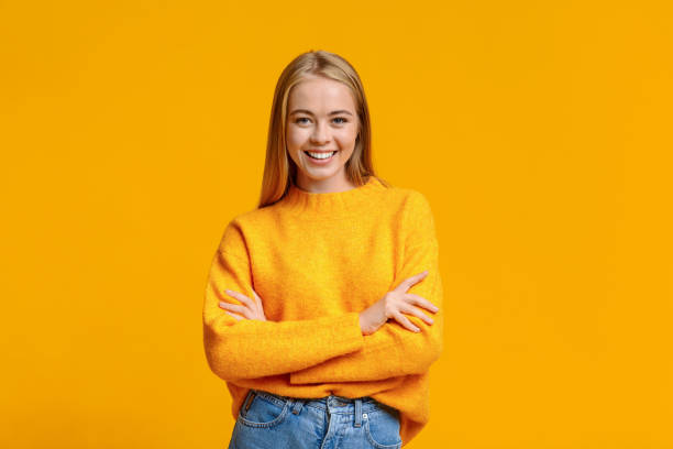 istock Beautiful young girl posing to camera with folded arms 1179983104