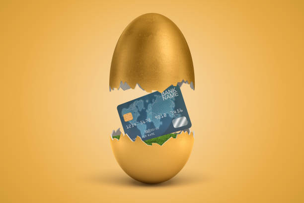 istock 3d rendering of gold egg cracked in two, upper half levitating in air, plastic credit card on green grass in lower half. 1179984727