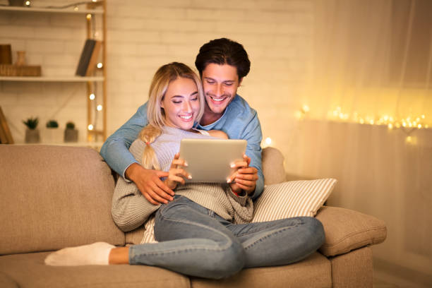 istock Loving couple chatting with friends on tablet 1179986104