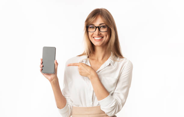 istock Woman Pointing Finger At Smartphone Blank Screen, Isolated, Mockup 1179989591