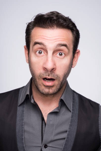 istock Surprised Young Man in Front of Gray Background 1179989736