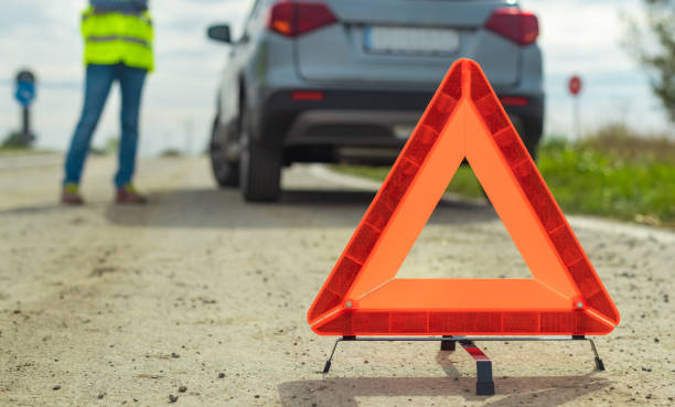 istock Vehicle breakdown and warning triangle on the road 1179991375