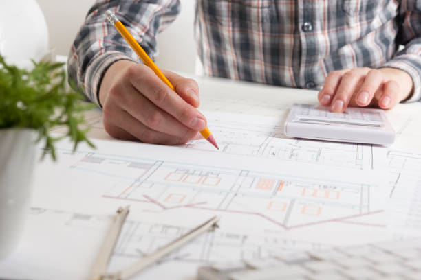 architects working on blueprint, real estate project. architect workplace - architectural project, blueprints, ruler, calculator, laptop and divider compass. construction concept. engineering tools. - housing project organization meeting real estate imagens e fotografias de stock