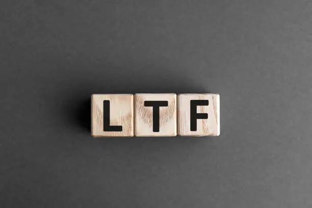 LTF - acronym from wooden blocks with letters, abbreviation LTF Long Term Equity Mutual Fund and RMF Retirement Mutual Fund concept, gray background
