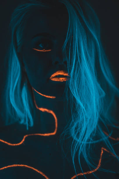 istock Close-up portrait in ultraviolet light. Face painted with glow 1179992414