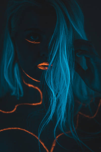 istock Close-up portrait in ultraviolet light. Face painted with glow 1179992523