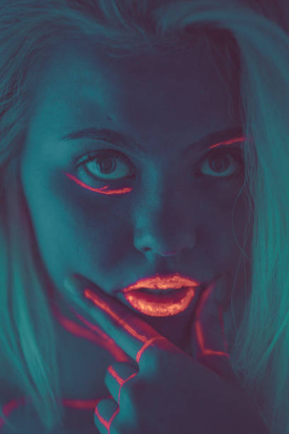 istock Close-up portrait in ultraviolet light. Face painted with glow 1179992733