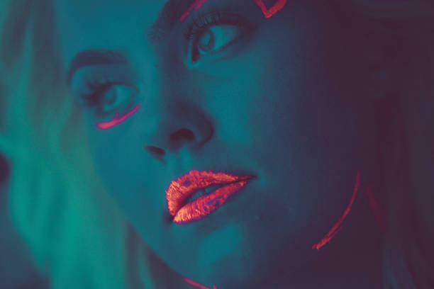 istock Close-up portrait in ultraviolet light. Face painted with glow 1179992810