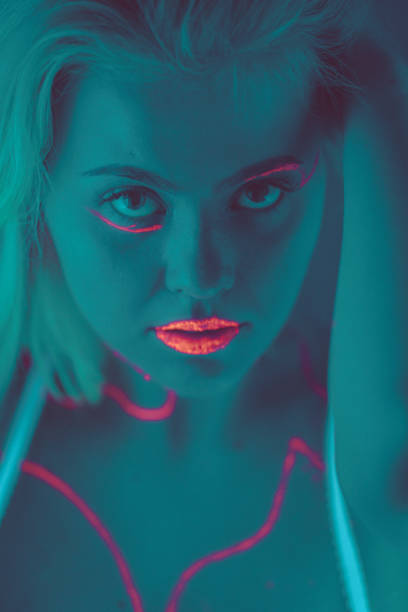 istock Close-up portrait in ultraviolet light. Face painted with glow 1179992884