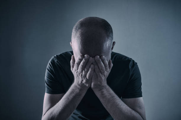 Disappointment or Depression Shocked, stressed, depressed or plain tired mature man with head in hands. post traumatic stress disorder photos stock pictures, royalty-free photos & images