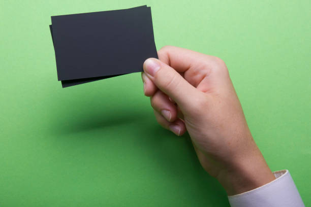 istock Hand holding white business card on white background 1179994181