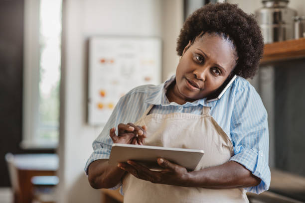 istock Mature African American cook using a tablet and cellphone 1179996090