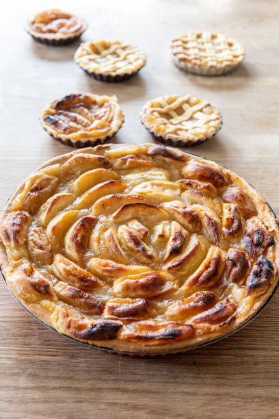 istock Homemade apple pies on a wooden table in a kitchen 1179998982