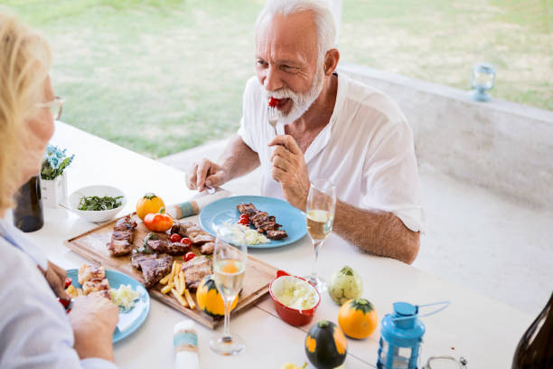 istock Elderly couple eating outside 1180000559