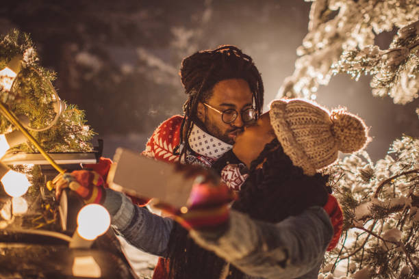 Couple arrived home with Christmas tree, it is snowy weather and everything need to be perfect for Christmas, they take selfie for social networks