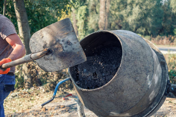 istock Builder preparing fresh concrete in a cement mixer 1180000650