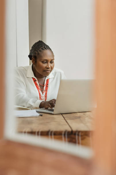 istock Mature African American female entrepreneur working inside her home office 1180001775