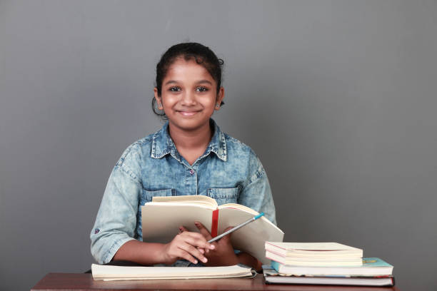 istock Young girl with her books in the study room 1180001910