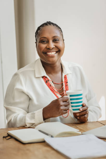 istock African American female entrepreneur smiling while working at home 1180002087