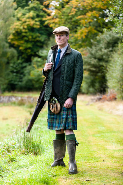 istock man carrying rifle on riverbank 1180007857