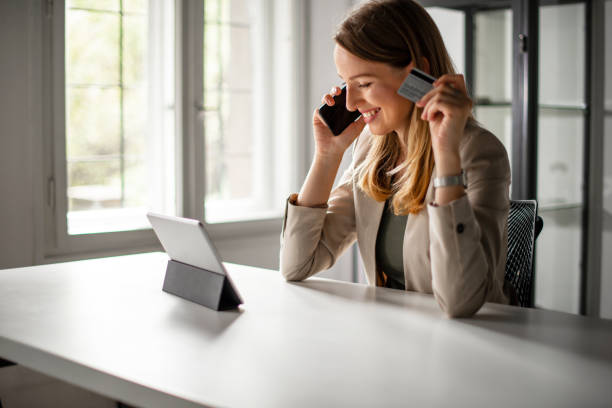 istock Smiling Woman Paying with Cedit Card Online 1180009808