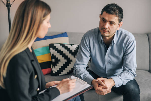 istock Mid age man having on on one counselling meeting 1180010612