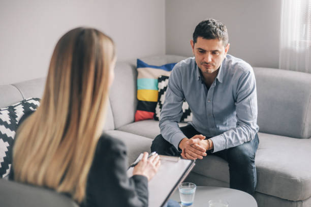 istock Mid age man having on on one counselling meeting 1180010624