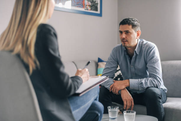 istock Mid age man having on on one counselling meeting 1180010627