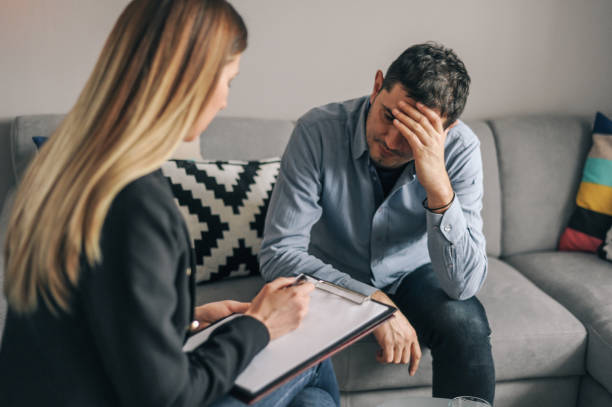 istock Mid age man having on on one counselling meeting 1180010645