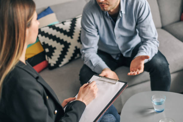 istock Mid age man having on on one counselling meeting 1180010672
