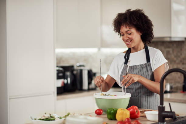 istock Woman mixing vegetables in bowl. 1180010852