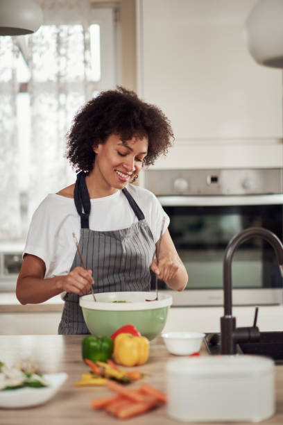 istock Woman mixing vegetables in bowl. 1180011528