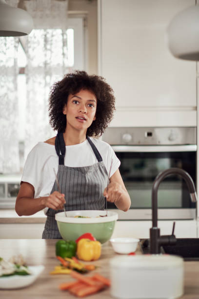 istock Woman mixing vegetables in bowl. 1180011675
