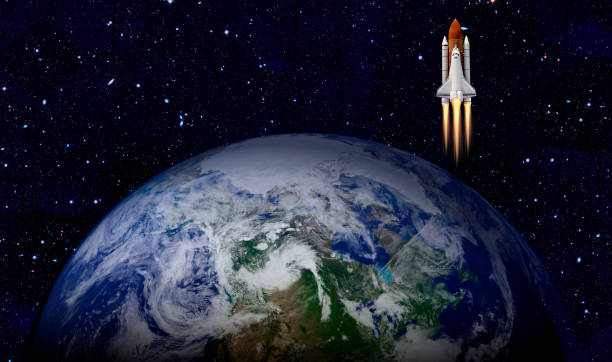 istock Space shuttle orbiting Earth planet. Elements of this image furnished by NASA 1180013055