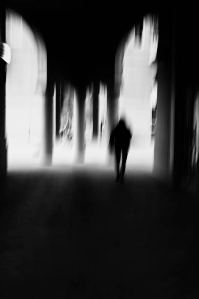 istock Blurred motion image of unrecognizable person walking in a urban environment. 1180013578