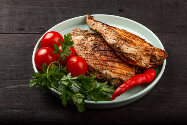 istock Tasty grilled chicken with fresh tomatoes on a dish 1180013580
