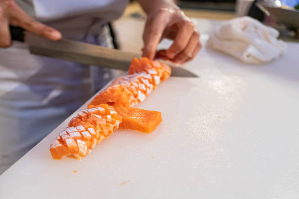 istock Chef preparing and cutting  fresh salmon in Japanese restaurant 1180014146