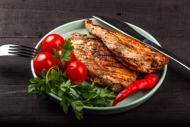 istock Tasty grilled chicken with fresh tomatoes on a dish 1180014211