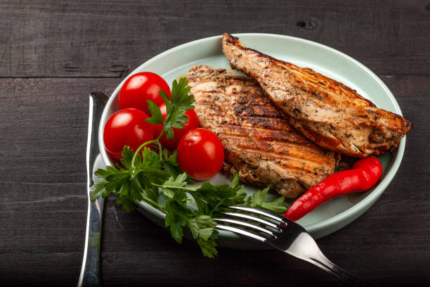 istock Tasty grilled chicken with fresh tomatoes on a dish 1180014233