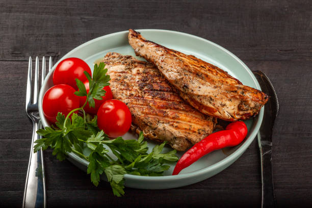 istock Tasty grilled chicken with fresh tomatoes on a dish 1180014347