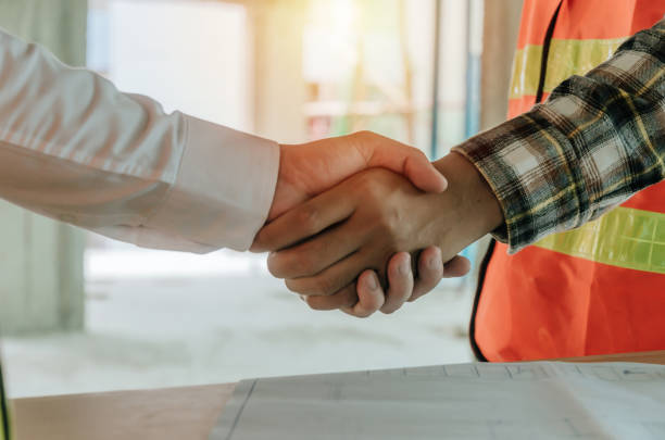 istock construction worker team hands shaking after consultation meeting to greeting start up plan new project contract in office center at construction site, teamwork, partnership and contractor concept 1180014361
