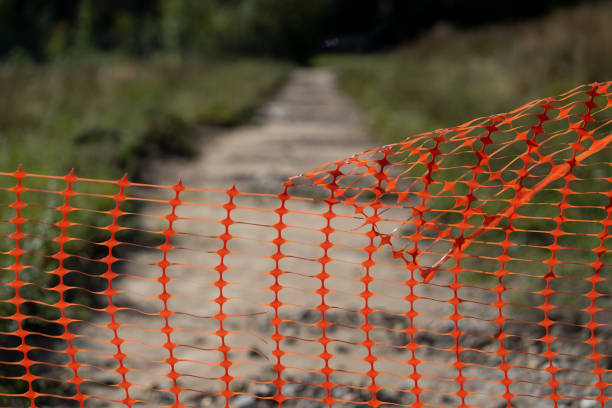 istock Perforated fence on a dirt road in autumn 1180016716