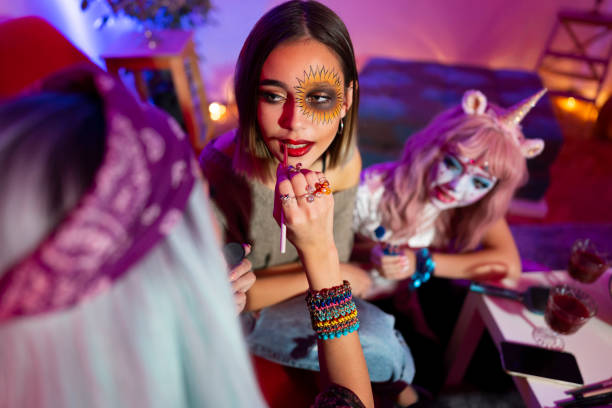 istock Doing her best friend's make-up for Halloween 1180017777