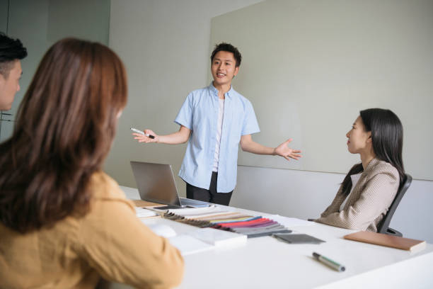 istock Energetic male Chinese designer pitching ideas for project 1180018106