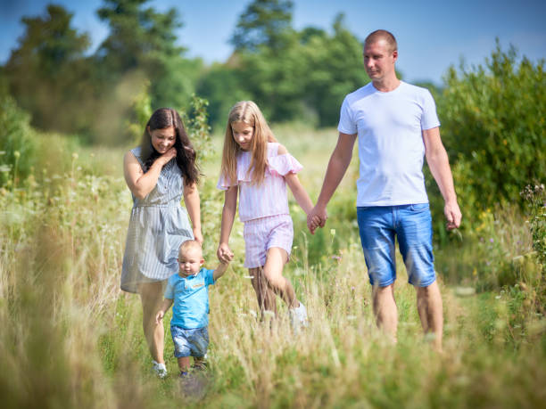 istock Family walking in field 1180018537
