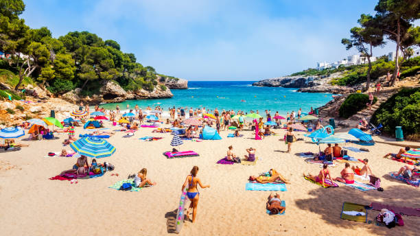 Tourists relaxing on Cala Esmeralda Beach, Santanyi, Mallorca stock photo