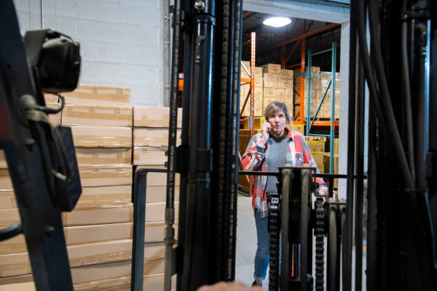 istock A warehouse and logistics safety topic.  A close call.  A forklift driver almost colliding with a pedestrian. 1180021231